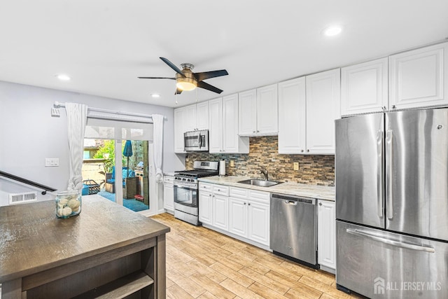 215 Kingsberry Dr, Franklin Twsp, NJ 08873 - kitchen featuring appliances with stainless steel finishes, white cabinetry, ceiling fan, tasteful backsplash, and recessed lighting