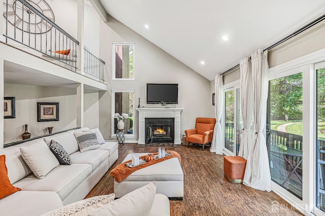 215 Kingsberry Dr, Franklin Twsp, NJ 08873 - living area featuring wood finished floors, high vaulted ceiling, a fireplace with flush hearth, and recessed lighting