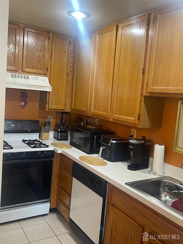 4215 Birchwood Ct, North Brunswick, NJ 08902 - kitchen with gas range, dishwasher, extractor fan, light tile patterned floors, and light countertops