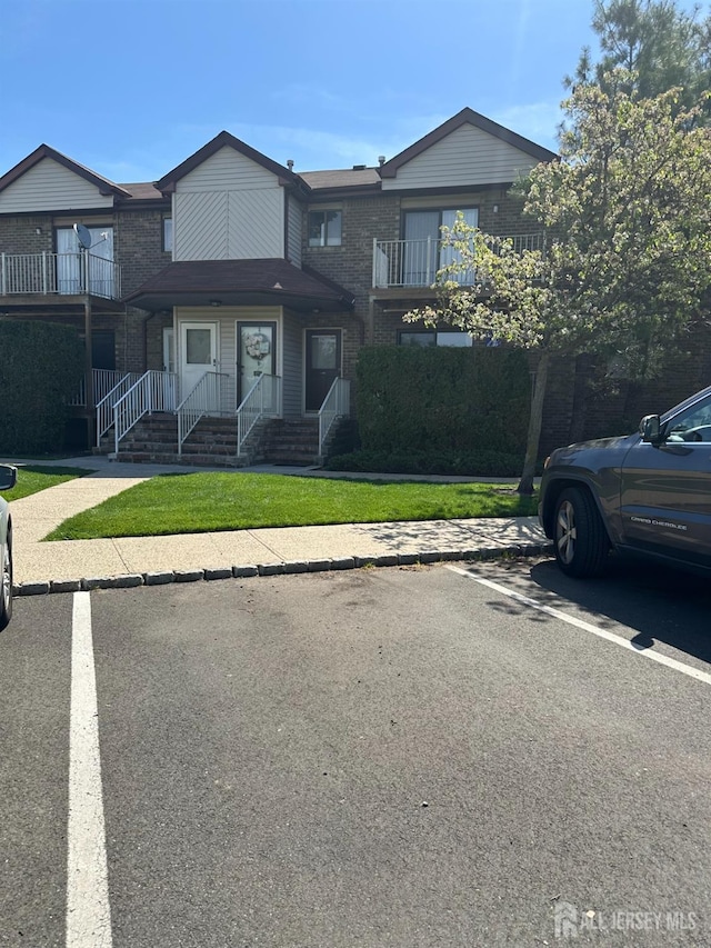 4215 Birchwood Ct, North Brunswick, NJ 08902 - multi unit property featuring a balcony, uncovered parking, and brick siding