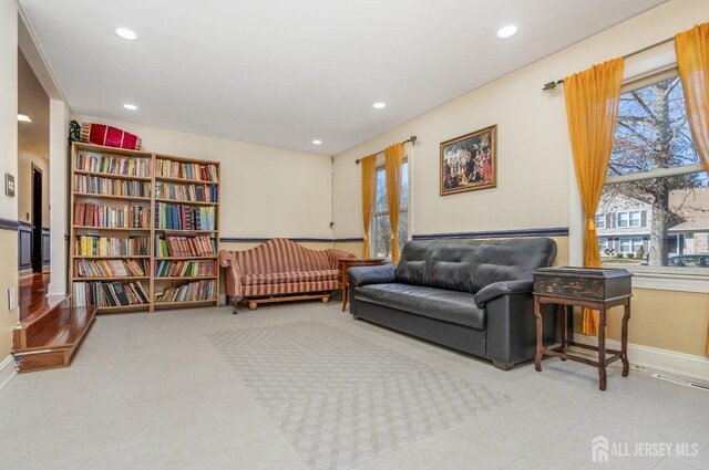 sitting room featuring recessed lighting, a healthy amount of sunlight, and baseboards