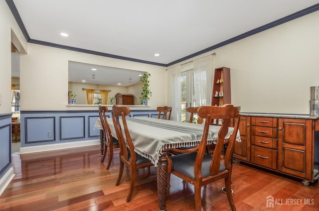 dining area featuring recessed lighting, crown molding, and wood finished floors