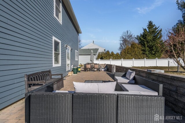 view of patio with outdoor dining space, outdoor lounge area, and a fenced backyard