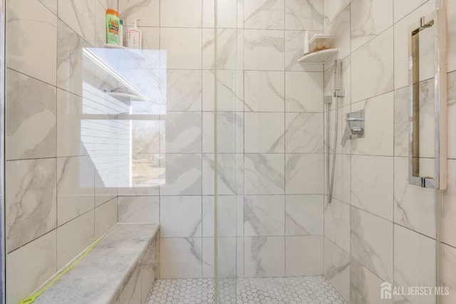 bathroom with tiled shower