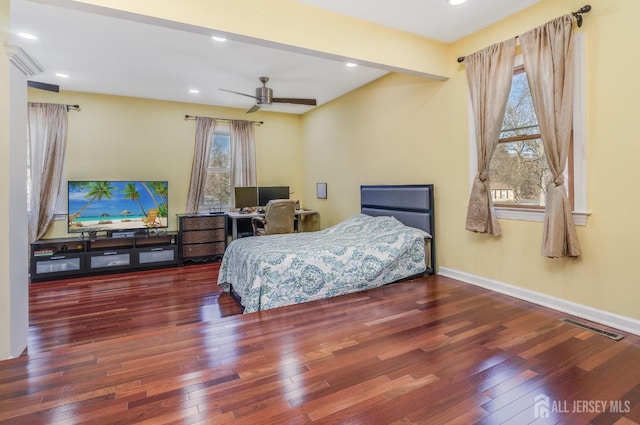 bedroom featuring visible vents, baseboards, beamed ceiling, hardwood / wood-style floors, and recessed lighting