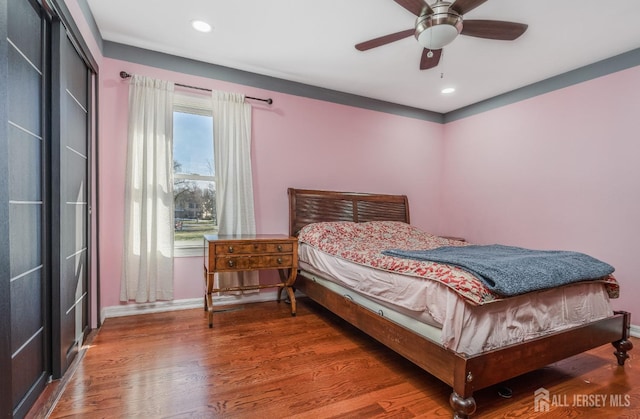 bedroom featuring recessed lighting, wood finished floors, and baseboards