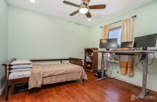 bedroom with wood finished floors and a ceiling fan