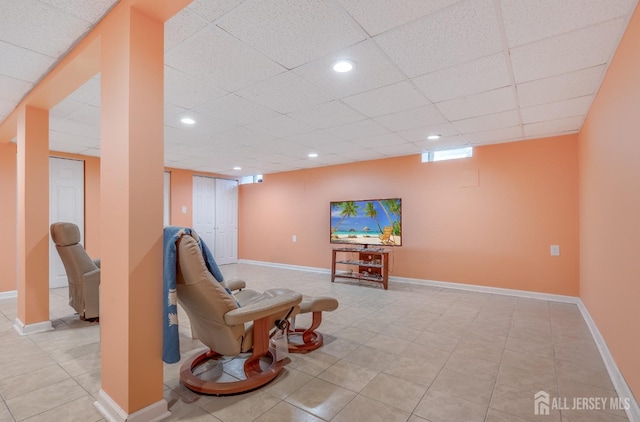 sitting room with light tile patterned flooring, recessed lighting, a paneled ceiling, and baseboards