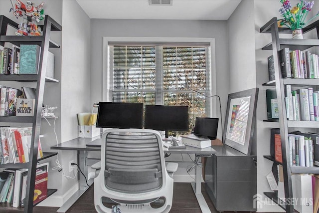 home office with visible vents, baseboards, and wood finished floors