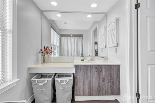 bathroom with plenty of natural light, recessed lighting, vanity, and visible vents