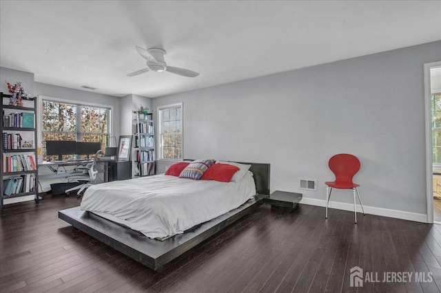 bedroom featuring visible vents, baseboards, and hardwood / wood-style flooring