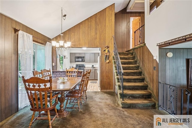 116 Whitman St, Carteret, NJ 07008 - dining area featuring wood walls, dark carpet, stairway, vaulted ceiling, and a chandelier