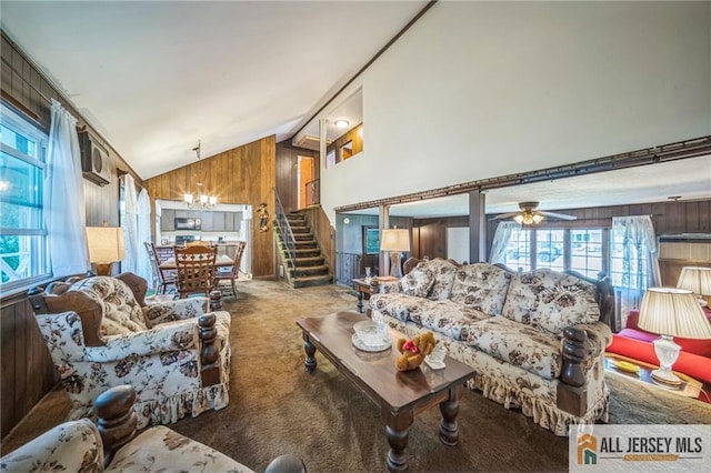 116 Whitman St, Carteret, NJ 07008 - carpeted living room with wood walls, plenty of natural light, a chandelier, high vaulted ceiling, and a ceiling fan