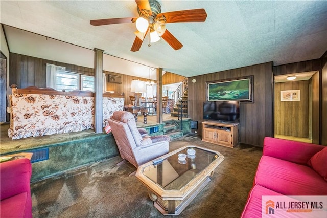 116 Whitman St, Carteret, NJ 07008 - carpeted living area with wooden walls, ceiling fan, and a textured ceiling