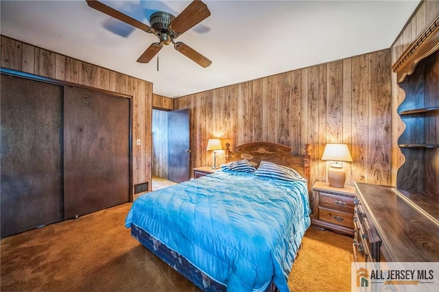 116 Whitman St, Carteret, NJ 07008 - bedroom with carpet flooring, wooden walls, a closet, and ceiling fan