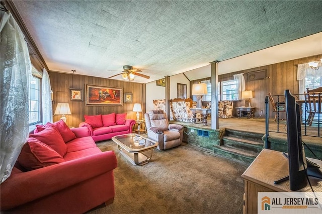 116 Whitman St, Carteret, NJ 07008 - carpeted living room with wooden walls and a ceiling fan