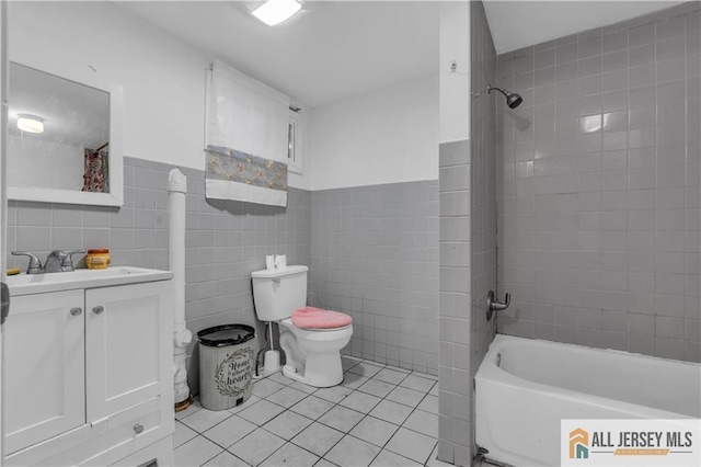 18 Lee Ave, New Brunswick, NJ 08901 - full bath featuring tile walls, toilet, tile patterned floors, vanity, and shower / bathing tub combination