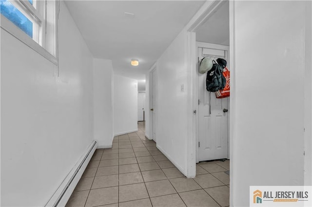 hallway with light tile patterned flooring and a baseboard radiator