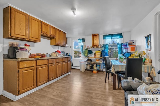 kitchen featuring light wood-type flooring and brown cabinets