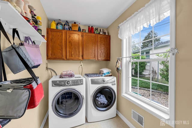 washroom featuring cabinets and washer and dryer