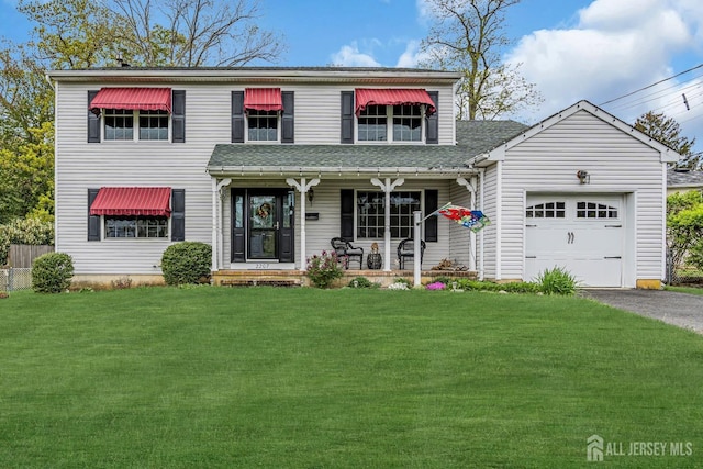 view of property featuring a garage, a porch, and a front lawn