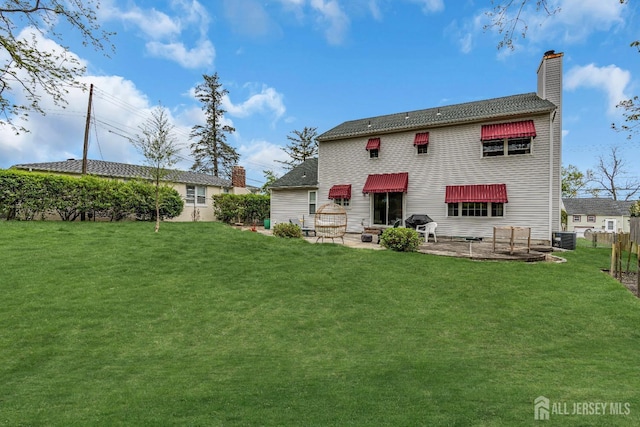 back of house featuring central AC, a yard, and a patio area