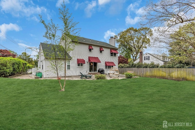 back of house with a yard and a patio area