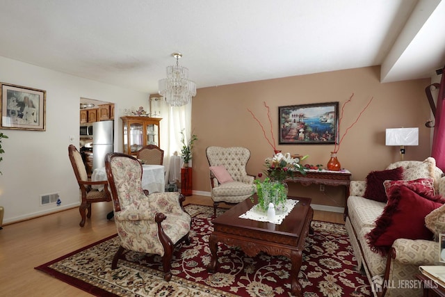 1-G Quincy Cir S, Brunswick, NJ 08810 - living room with a chandelier, light wood finished floors, and baseboards