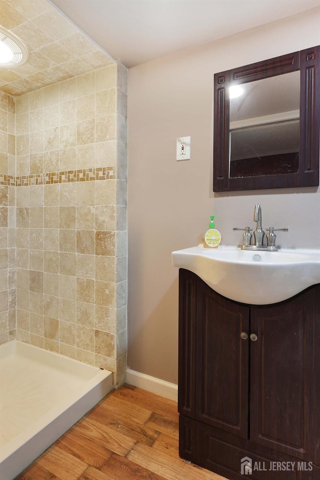 1-G Quincy Cir S, Brunswick, NJ 08810 - full bath with wood finished floors, vanity, baseboards, and tiled shower