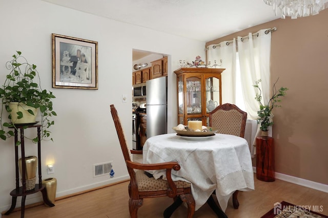 1-G Quincy Cir S, Brunswick, NJ 08810 - dining area featuring light wood-type flooring and baseboards