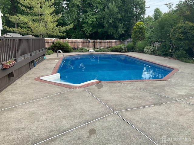 view of pool with a patio, a fenced backyard, and a fenced in pool