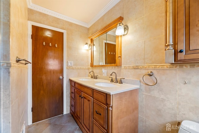 full bath with double vanity, tile walls, crown molding, and a sink