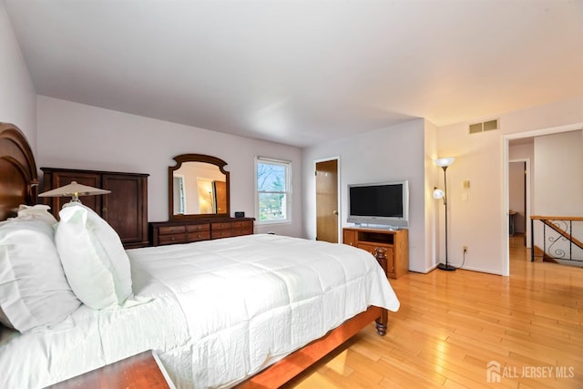 bedroom with visible vents and light wood-style floors