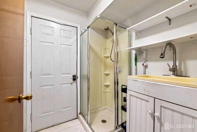 bathroom featuring a stall shower and vanity