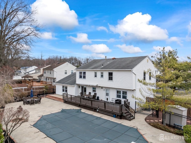 back of property featuring a patio, fence private yard, outdoor dining area, and a deck