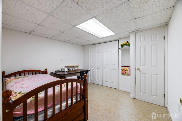 bedroom with a closet and a drop ceiling