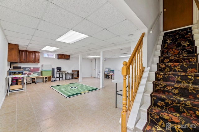 recreation room with a drop ceiling