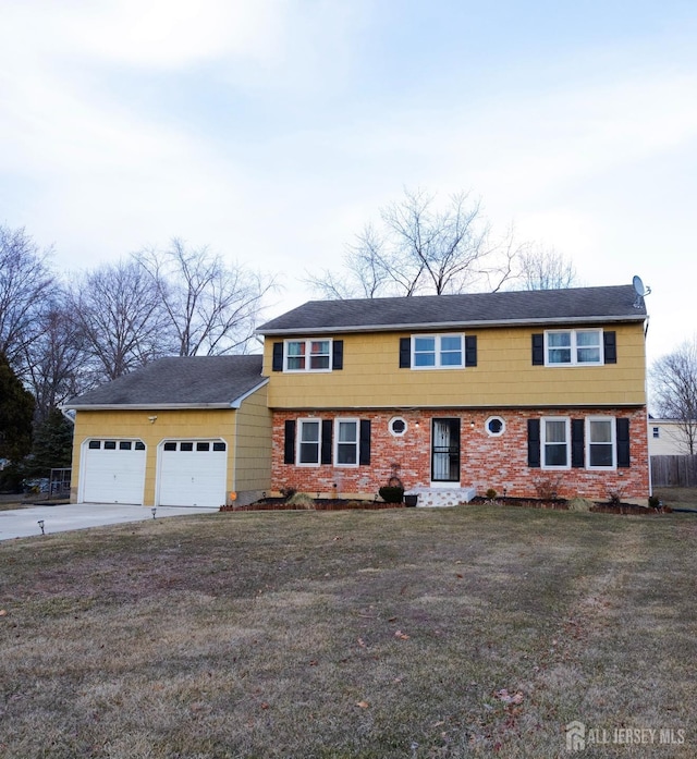 colonial house with a garage, driveway, and a front yard