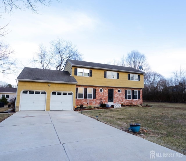 colonial inspired home featuring a front yard, a garage, and driveway