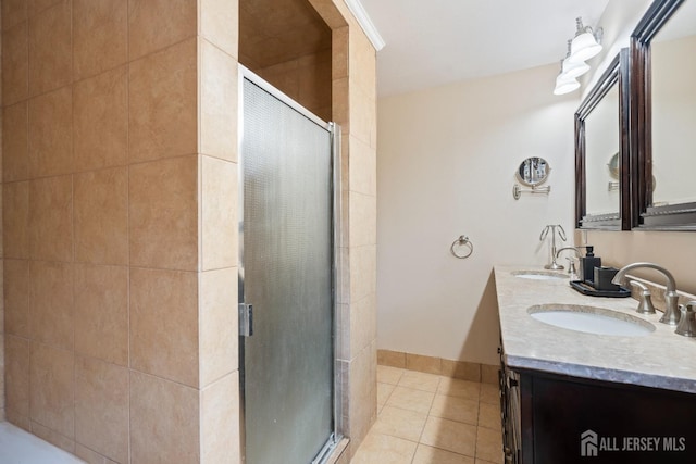 full bathroom featuring a shower stall, double vanity, a sink, and tile patterned floors