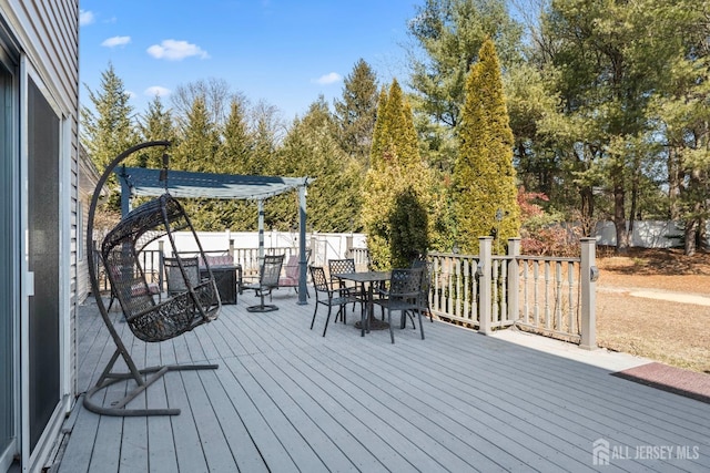 wooden deck featuring outdoor dining area and fence