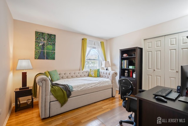 bedroom with a closet and light wood finished floors