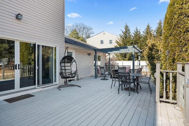 deck featuring outdoor dining area and a pergola