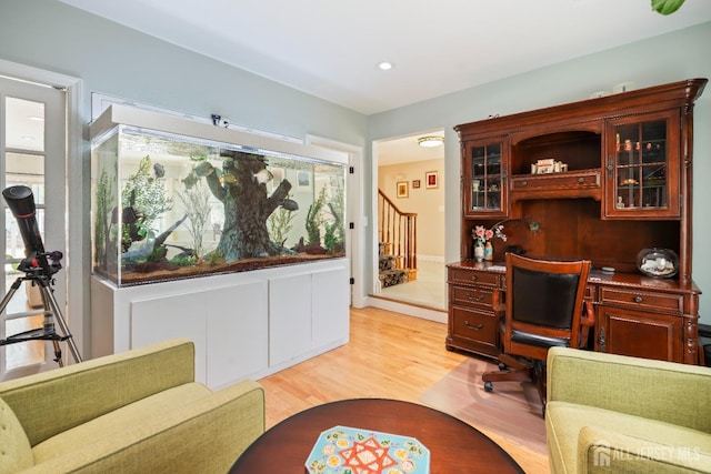 home office with light wood-style flooring and recessed lighting