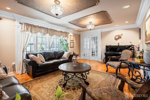 living area featuring french doors, crown molding, and wood finished floors