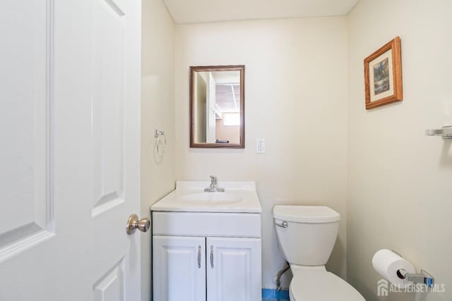 bathroom featuring toilet and vanity