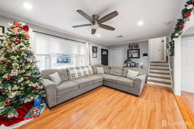 living room with ceiling fan, wood-type flooring, and ornamental molding