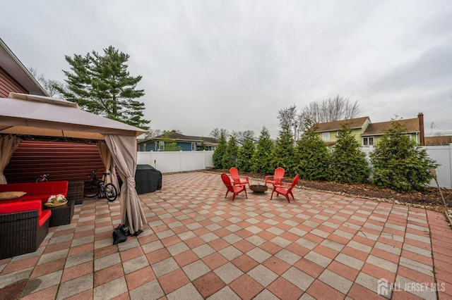 view of patio with a gazebo, area for grilling, and an outdoor fire pit