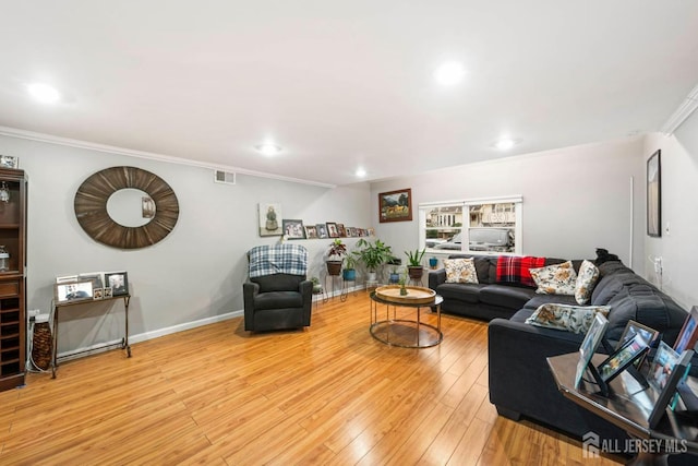 living room featuring hardwood / wood-style floors and ornamental molding