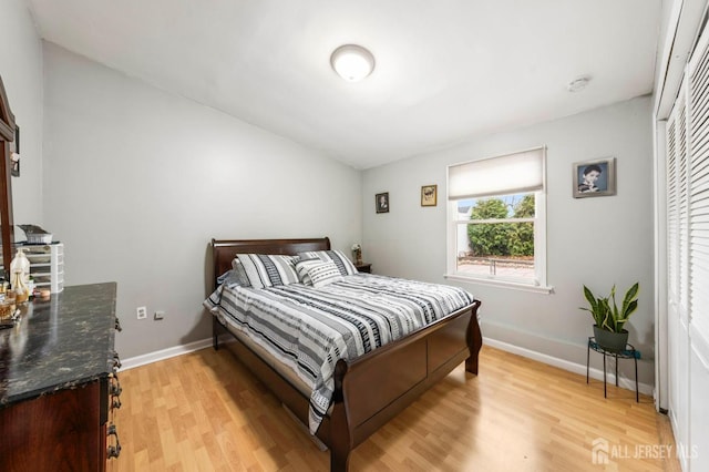 bedroom with a closet and light hardwood / wood-style flooring